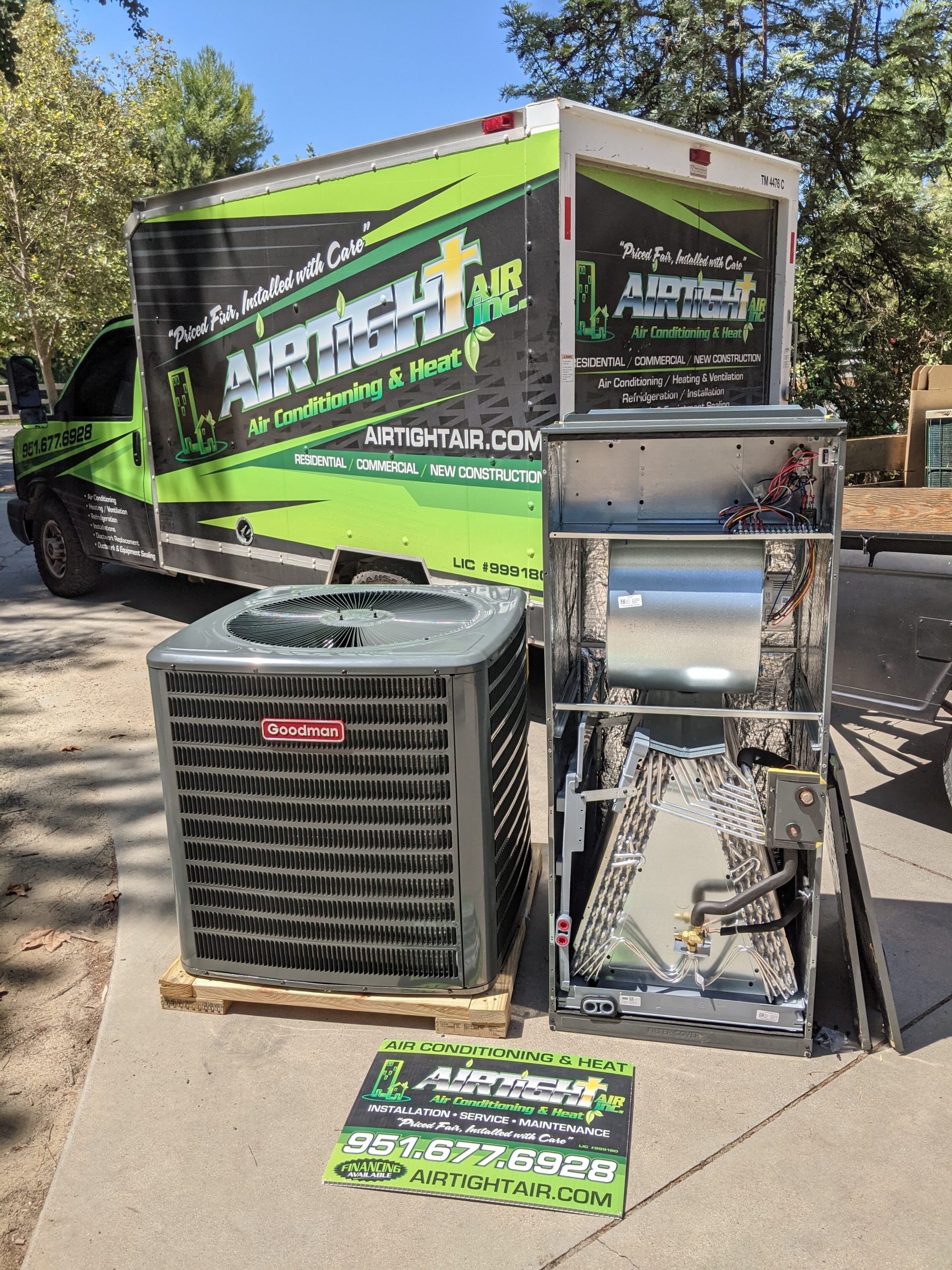 An AirTight Air, Inc service truck parked outside a home, with a new HVAC unit sitting on the sidewalk
